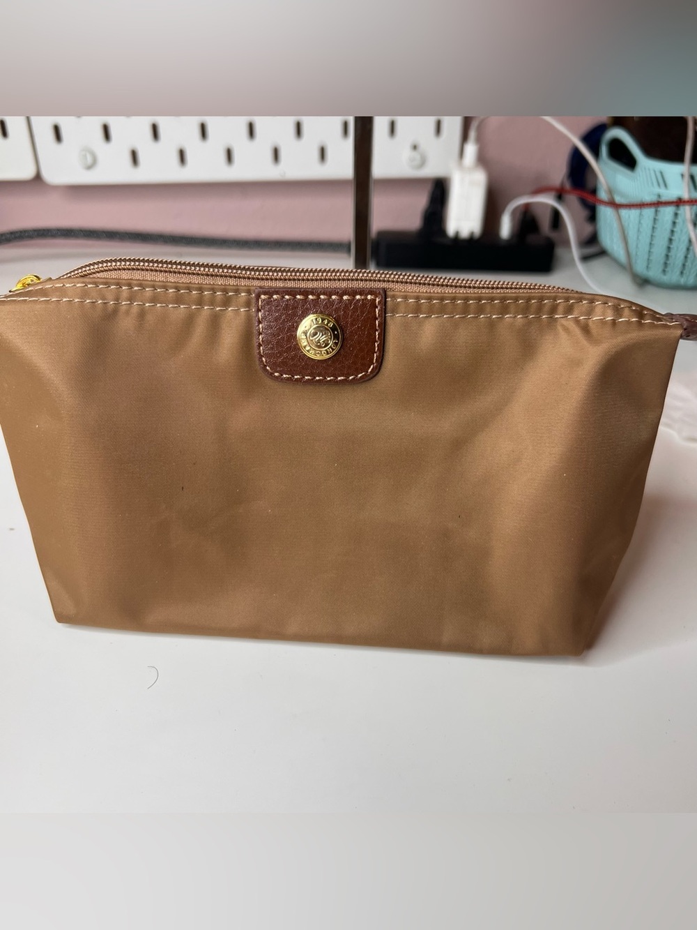 Longchamp Le Pliage Original pouch features a signature gold-toned snap button